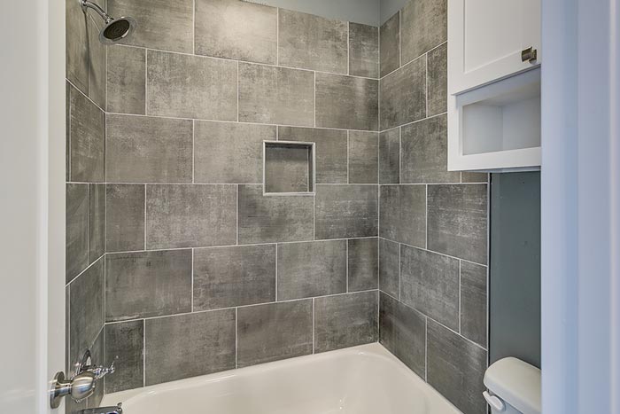Interior of a custom bathroom with tiled walls