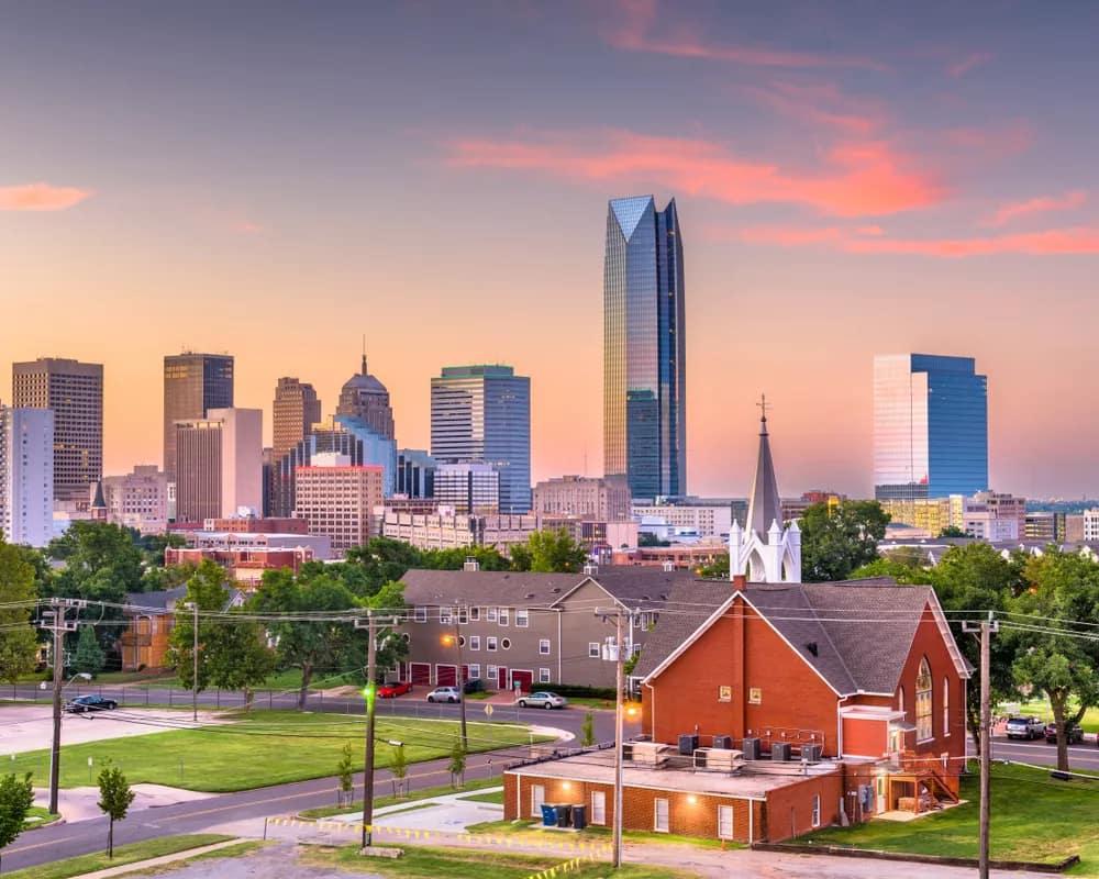 Oklahoma City home prices vs national average with OKC skyline and luxury home